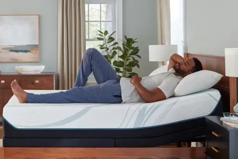 tempur-adapt-medium-man-laying-down-side-view
